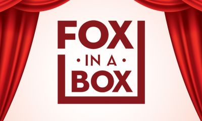 Fox in a box logo behind two parting curtains